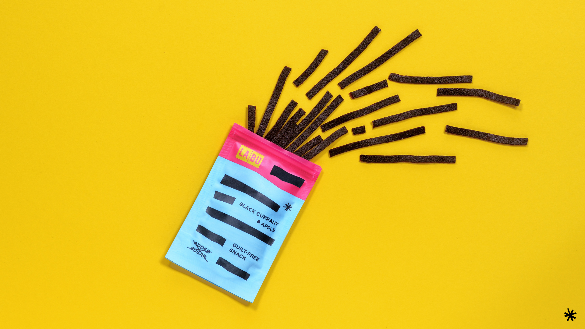 LABU black currant and apple snack packaging with fruit strips on a yellow background